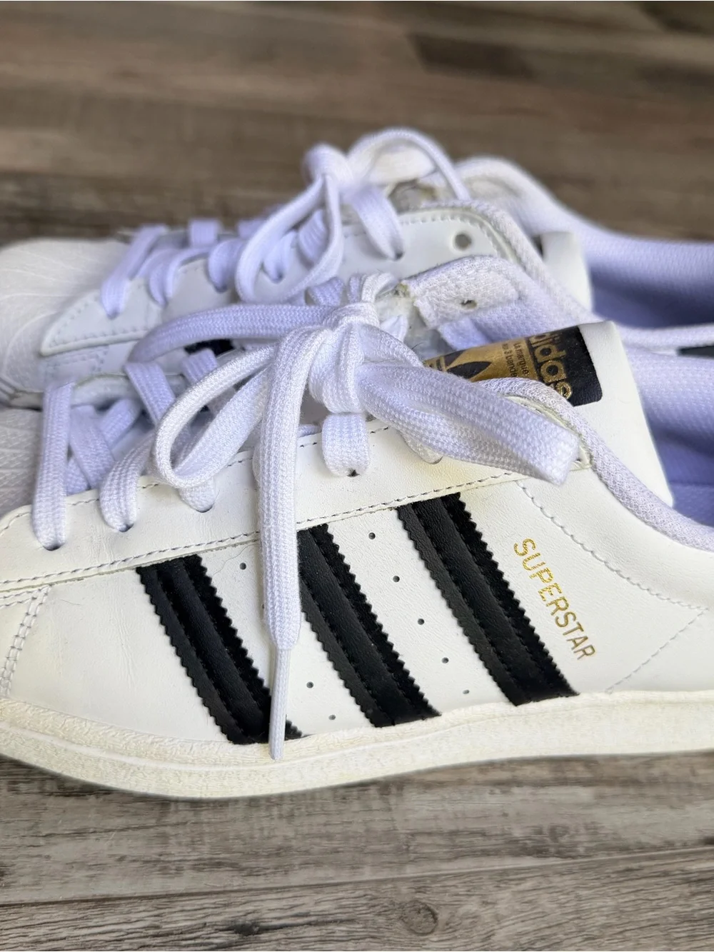 adidas White Sneakers with Black Stripes and Gold Detail